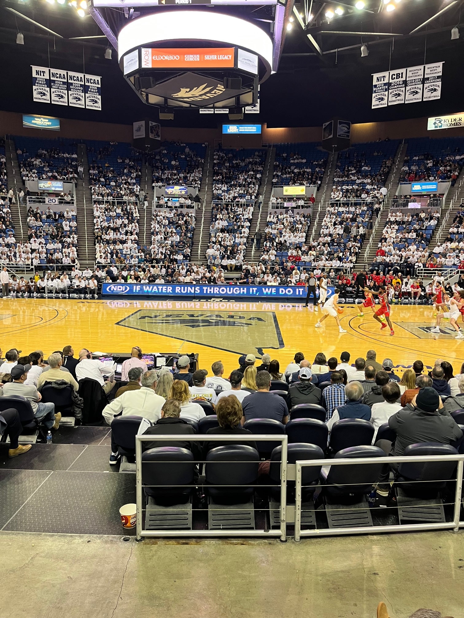 Basketball arena with crowd and NDI sponsorship